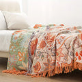 Fringed edge detail of the bohemian cotton throw blanket in warm earthy tones